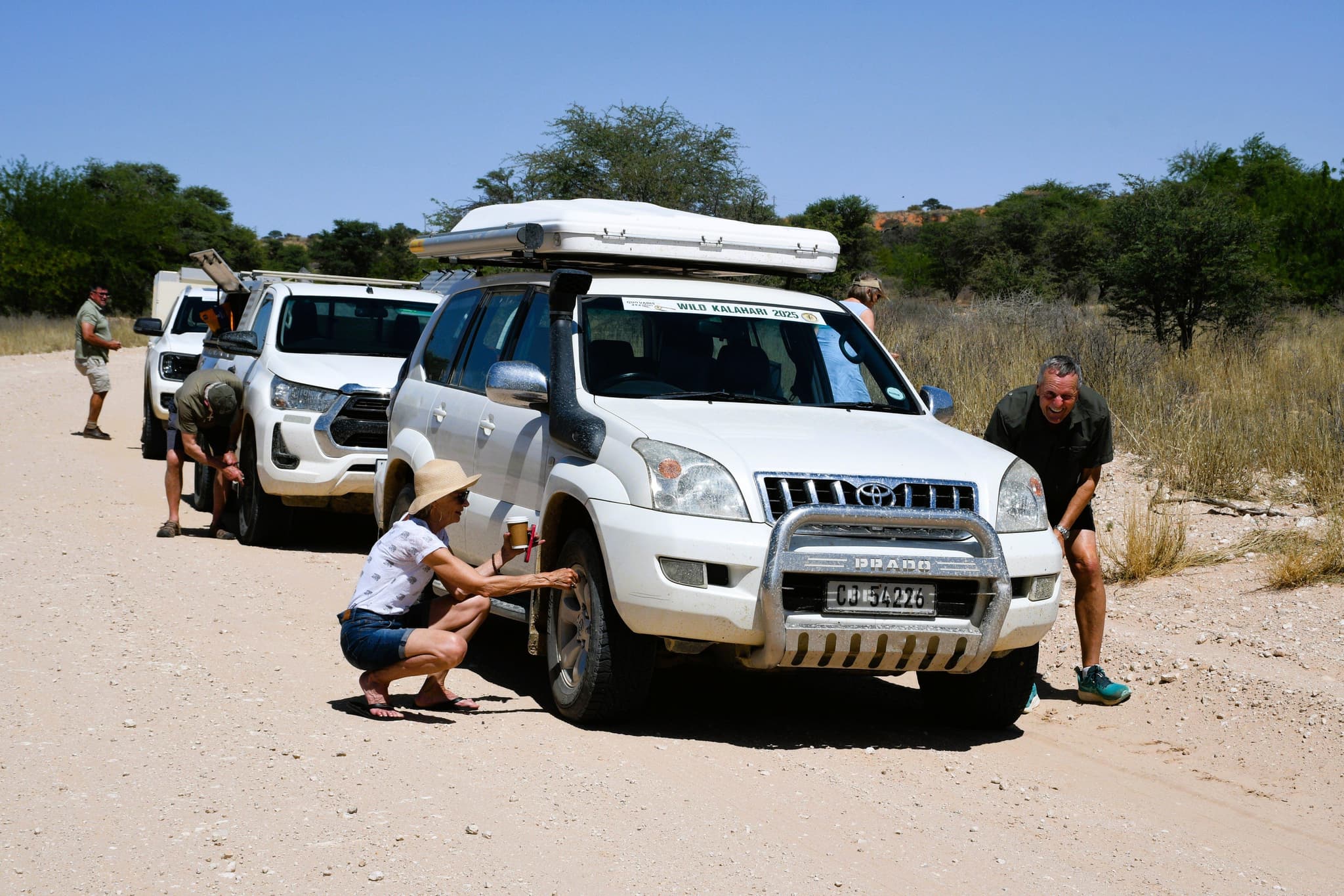 Quo Vadis 4x4 convoy stopped for a coffee break and tyre check on a Kalahari dirt road